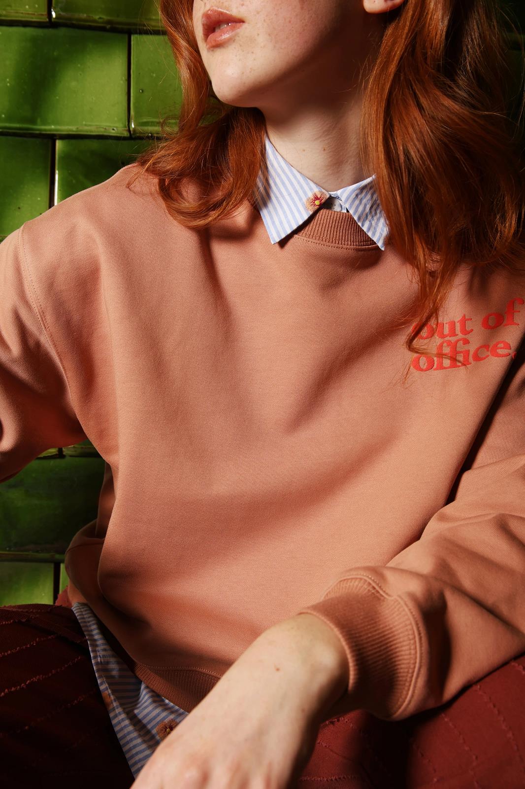 sweater with artwork 'OUT OF OFFICE'
